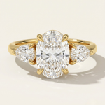 MOHSTEN Valencia oval and pear diamond trilogy engagement ring in 18ct yellow gold showcasing an elongated oval centre diamond paired with two sharp pear-cut side stones.