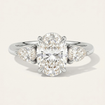MOHSTEN Valencia oval and pear diamond trilogy engagement ring in polished platinum showcasing an elongated oval centre diamond and two sharp pear-cut side stones.