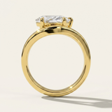MOHSTEN Venice pear diamond solitaire engagement ring in 18ct yellow gold from a through-finger circular profile view, highlighting the polished round band and the low-profile setting architecture casting a crisp shadow.