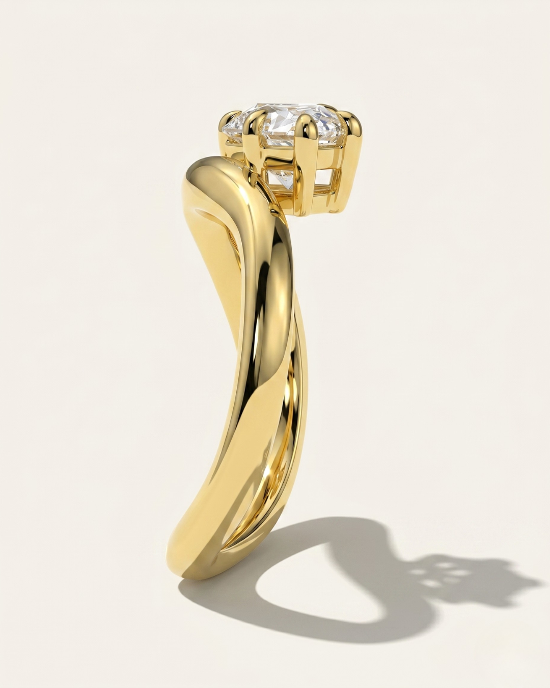 MOHSTEN Venice pear diamond solitaire engagement ring in 18ct yellow gold showcasing a side profile through-finger view of the dramatic sweeping band architecture and low-profile prong setting casting a crisp studio shadow.