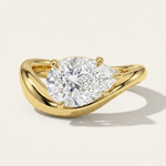 MOHSTEN Venice pear diamond solitaire engagement ring in 18ct yellow gold showcasing an east-west oriented pear diamond on a sleek, organic sweeping band casting a soft shadow on a minimalist studio background.