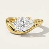 MOHSTEN Venice pear diamond solitaire engagement ring in 18ct yellow gold showcasing an east-west oriented pear diamond on a sleek, organic sweeping band casting a soft shadow on a minimalist studio background.