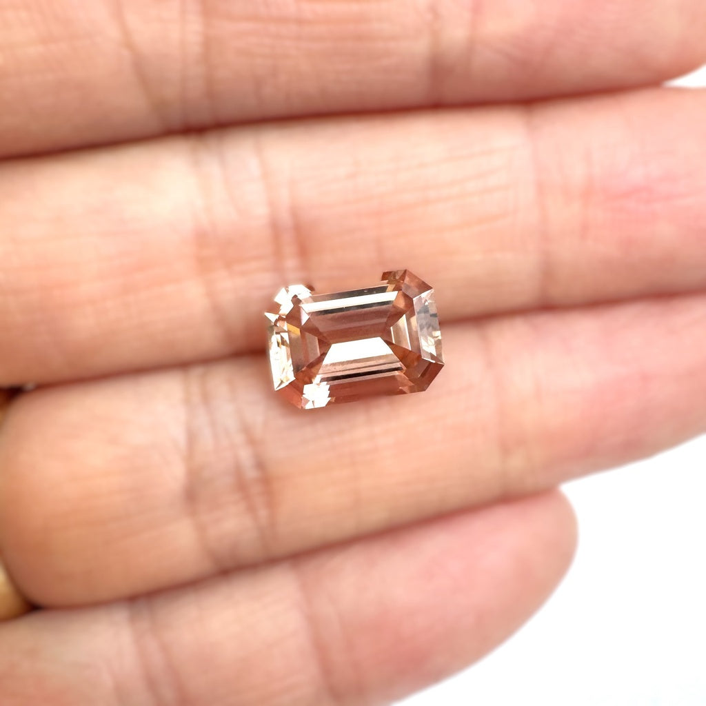 An emerald-cut peach tourmaline loose