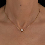 Woman wearing the MOHSTEN Solaris Diamond Pendant Necklace in 9ct yellow gold, featuring a round brilliant cut solitaire diamond in a refined cage setting.