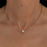 Woman wearing the MOHSTEN Solaris Diamond Pendant Necklace in 9ct yellow gold, featuring a round brilliant cut solitaire diamond in a refined cage setting.