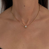 MOHSTEN Solaris Diamond Pendant Necklace in gold, featuring a single round brilliant cut diamond on a fine chain, modelled on a woman's neck.