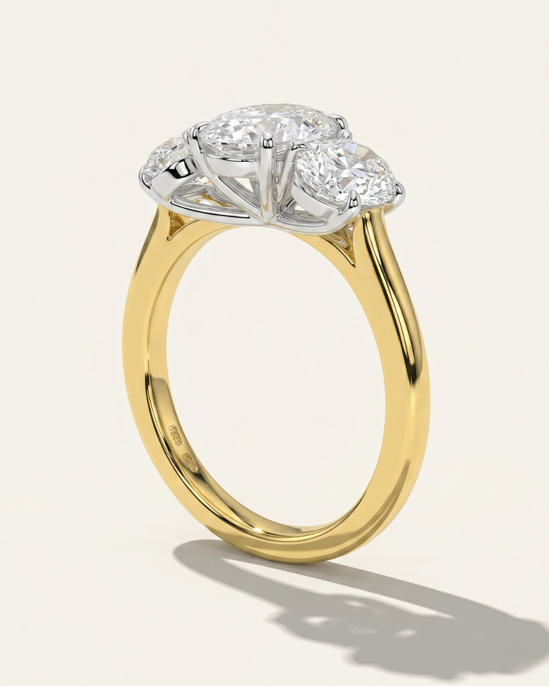 Side profile view of the MOHSTEN Sydney oval diamond trilogy engagement ring in 18ct yellow gold showcasing the architectural cathedral shoulder band and pinched wire gallery setting.