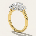 Side profile view of the MOHSTEN Sydney oval diamond trilogy engagement ring in 18ct yellow gold showcasing the architectural cathedral shoulder band and pinched wire gallery setting.