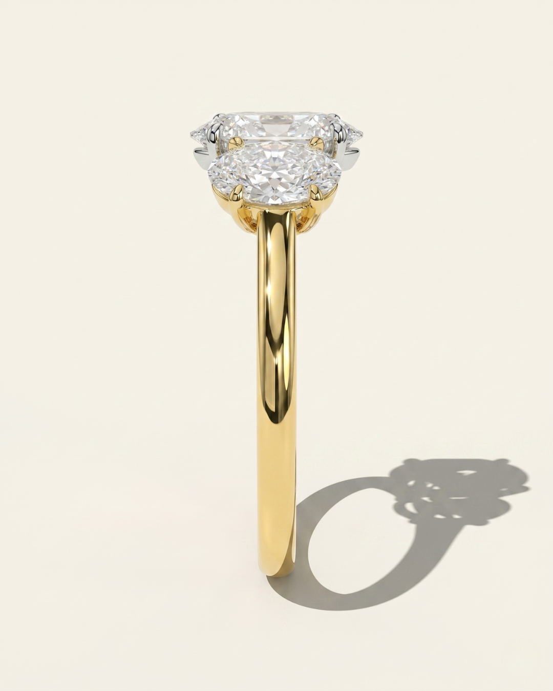 Side profile view of the MOHSTEN Sydney oval diamond trilogy engagement ring in 18ct yellow gold showcasing the high-polish comfort-fit band and the elegant three-stone setting architecture.