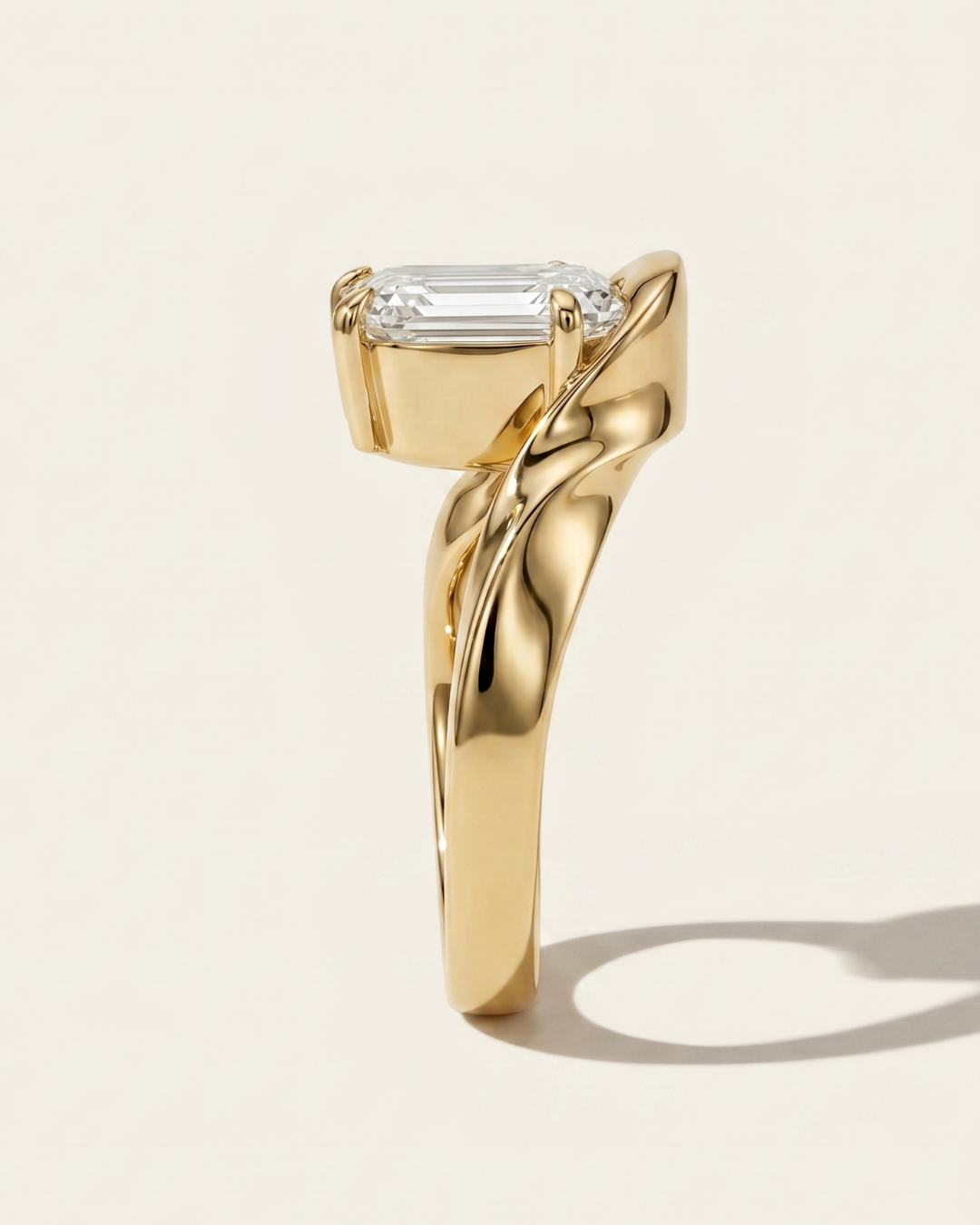 Side profile view of the MOHSTEN Tairua oval diamond solitaire engagement ring in 18ct yellow gold showcasing the heavy, sculptural curves of the architectural bypass ribbon band.