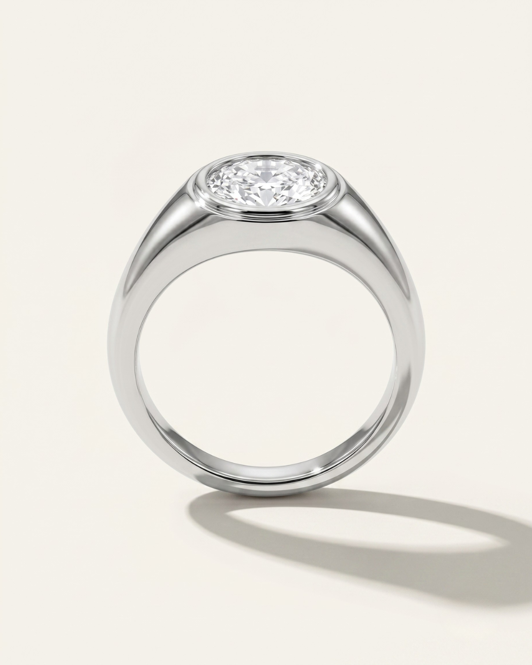 MOHSTEN Tova modern signet ring in platinum with east-west bezel set oval diamond.