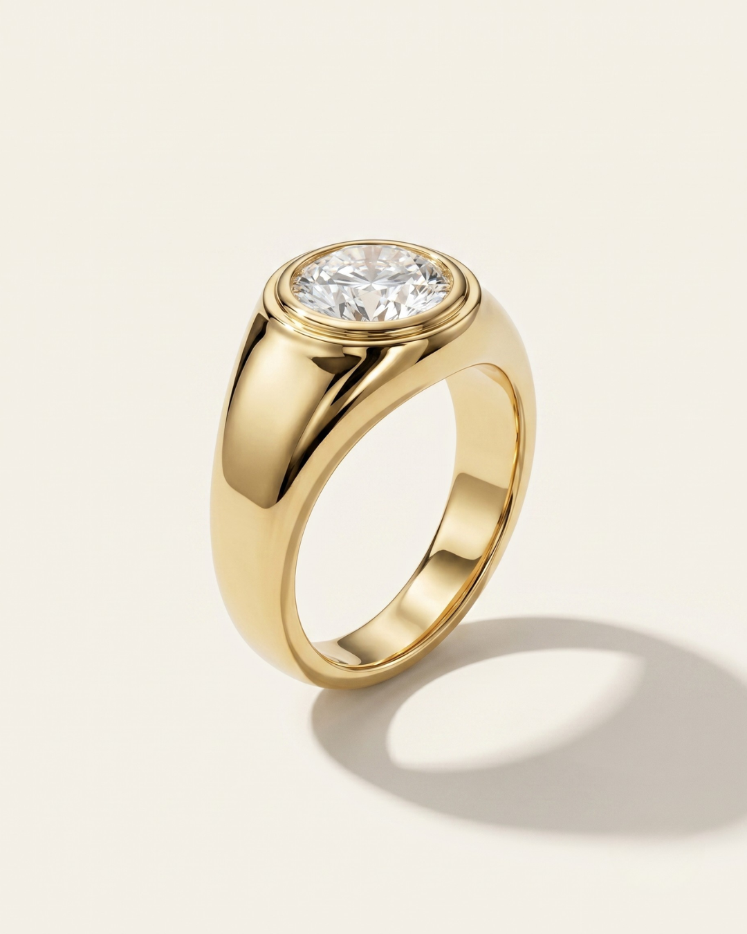 MOHSTEN Tova 18ct yellow gold signet ring with flush-set oval cut diamond.