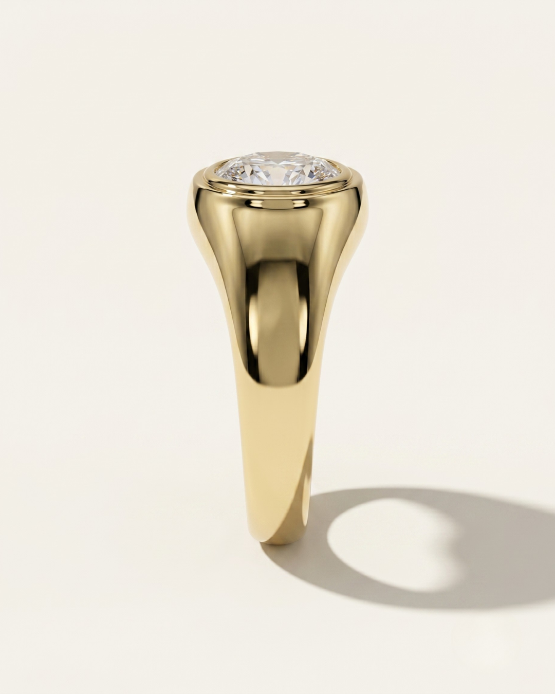 MOHSTEN Tova yellow gold thick band signet ring side profile with flush-set oval diamond.