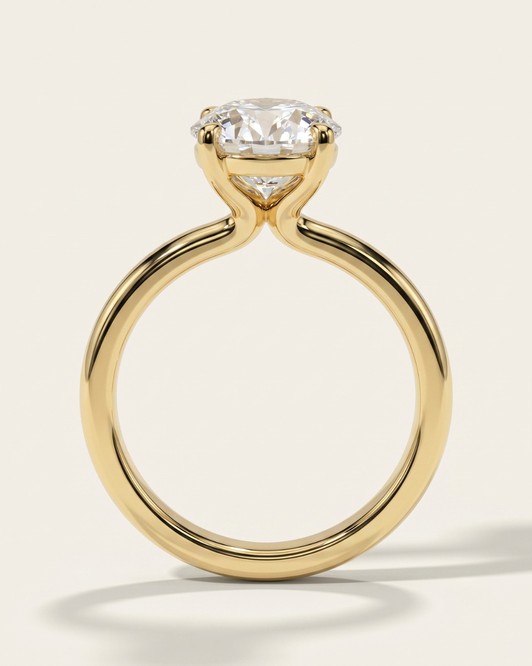Side profile view of the MOHSTEN Uluwatu round diamond solitaire engagement ring in 18ct yellow gold showcasing the sleek curves of the minimalist 4-prong basket setting