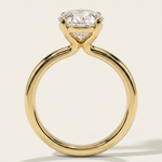 Side profile view of the MOHSTEN Uluwatu round diamond solitaire engagement ring in 18ct yellow gold showcasing the sleek curves of the minimalist 4-prong basket setting