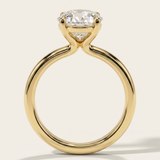 Side profile view of the MOHSTEN Uluwatu round diamond solitaire engagement ring in 18ct yellow gold showcasing the sleek curves of the minimalist 4-prong basket setting