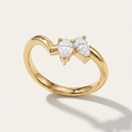 a yellow gold wishbone ring with asymmetric pear diamonds
