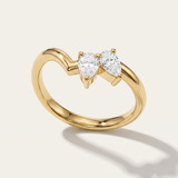 a yellow gold wishbone ring with asymmetric pear diamonds